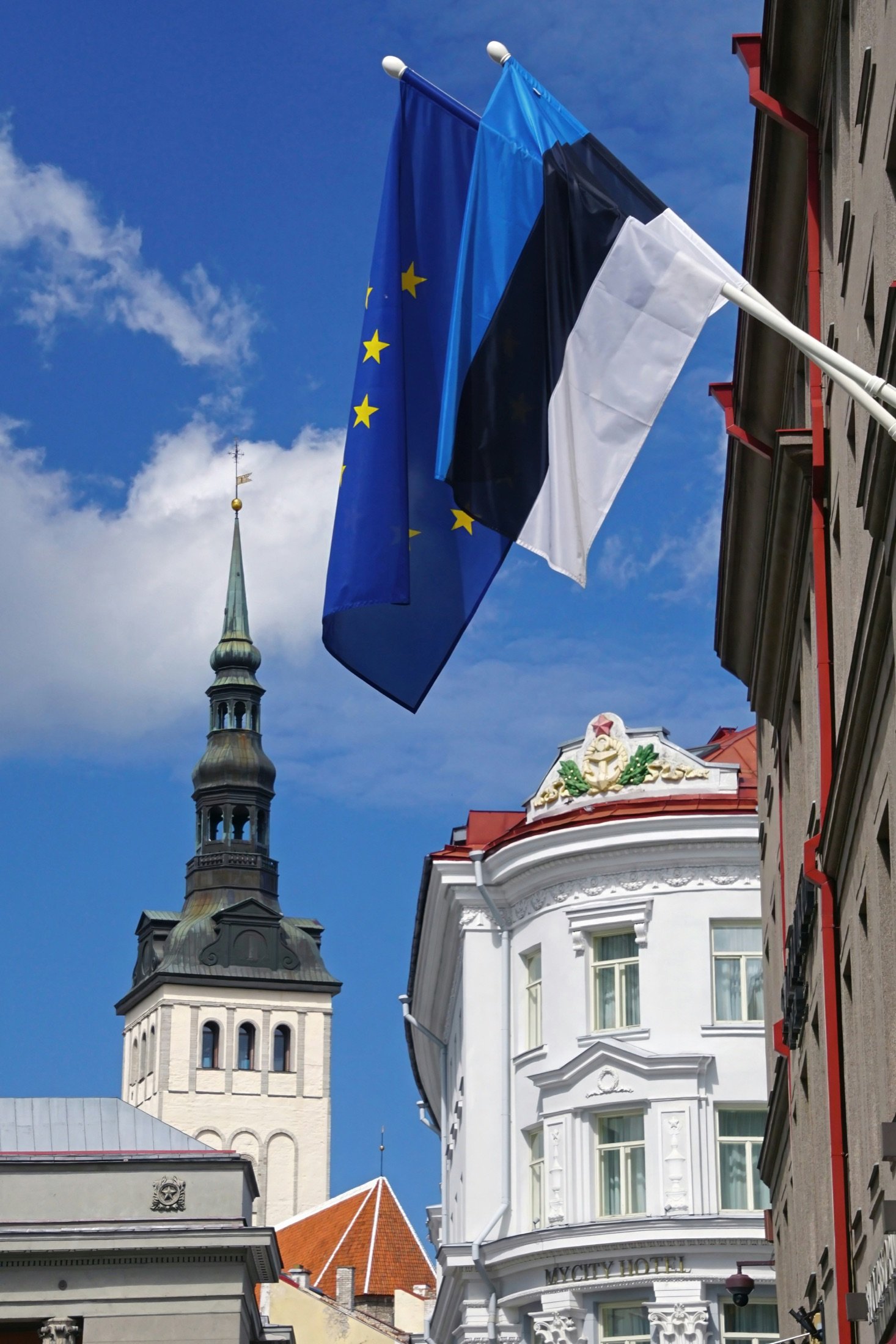 Estonian and EU flags against Tallinn's Old Town spires