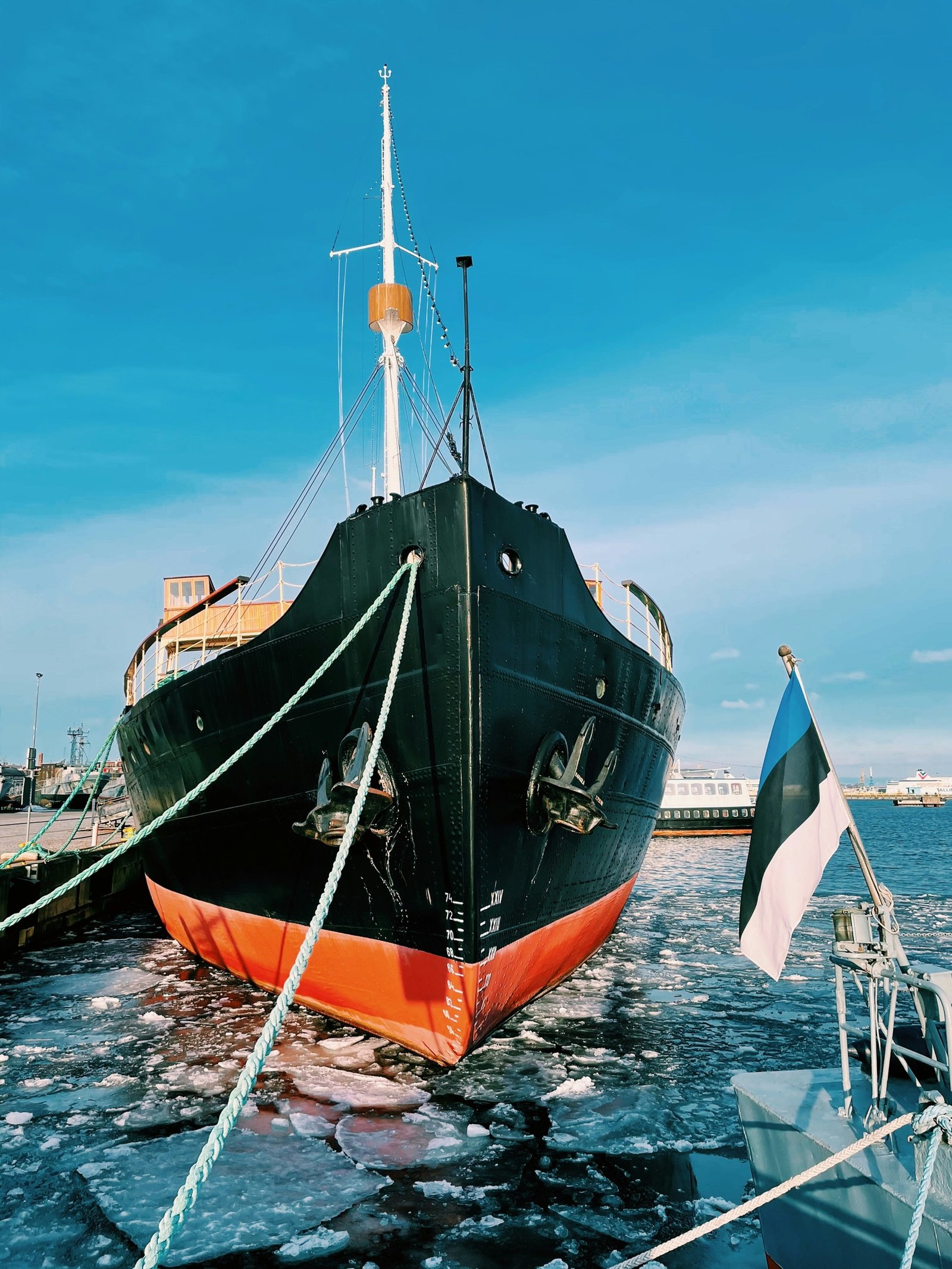 Icebreaker ship bow in Tallinn harbour, flying the Estonian flag